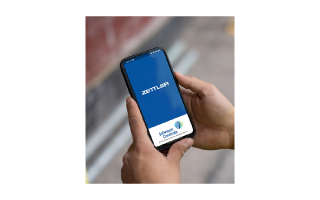 Close-up of a person looking a mobile phone displaying a Johnson Controls application