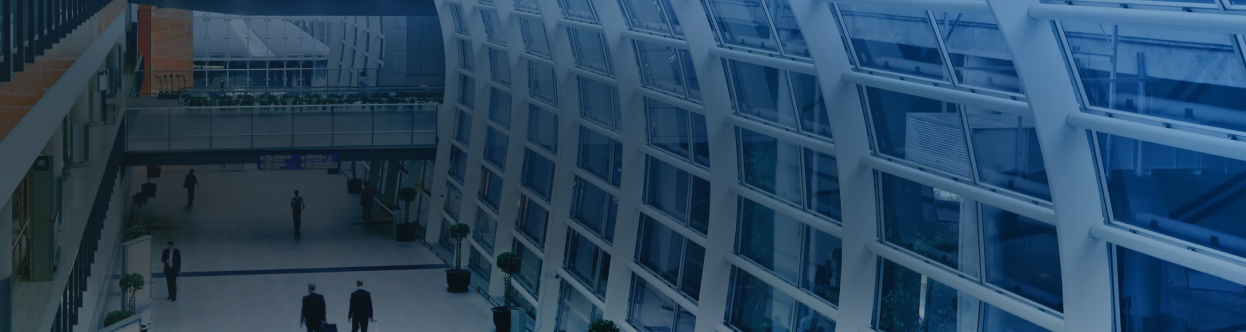 Aerial view of a passengers walking in an airport, overlaid with a blue gradient