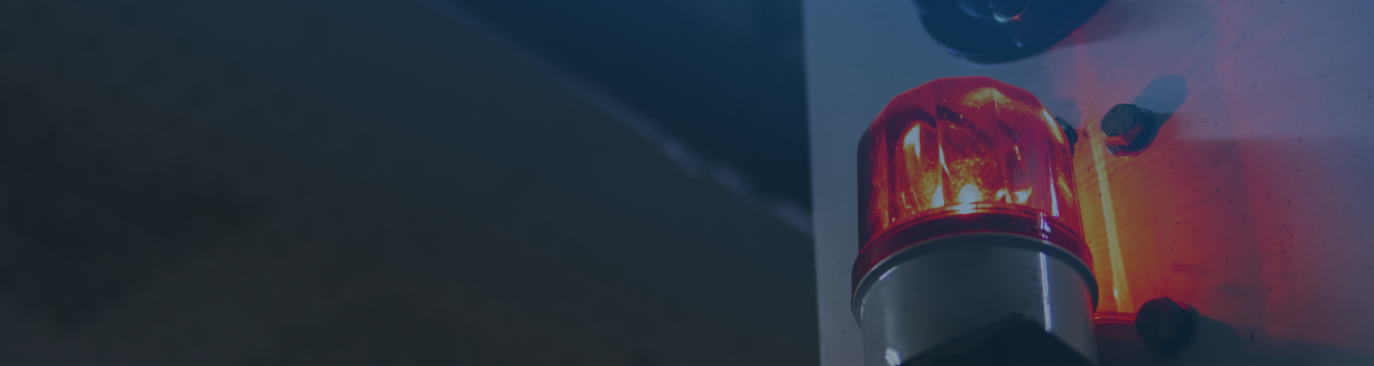 Close-up of a siren on an ambulance, overlaid with a blue gradient